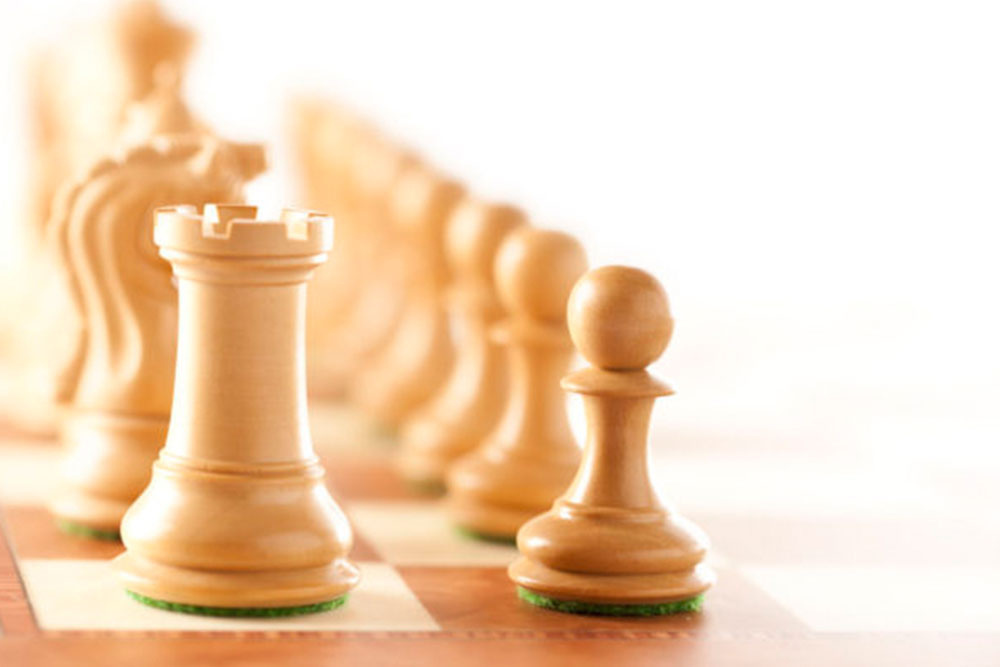 White-chess-pieces-on-a-chessboard-standing-closeup_ml-e1486941397627