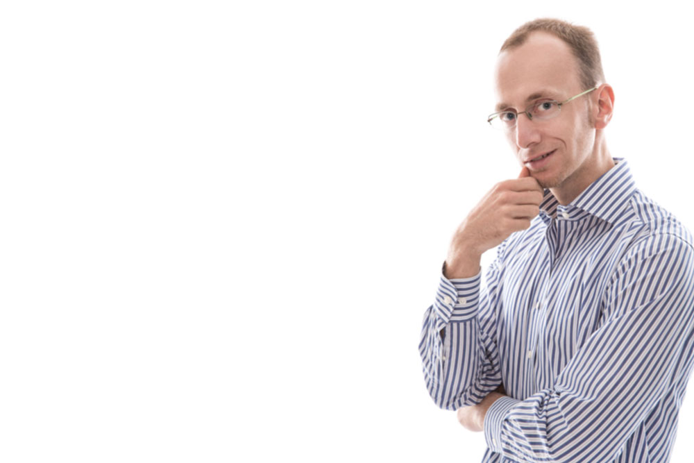 Businessman-with-glasses-looking-at-camera-white-background-_mirror-e1496634154646